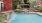 a pool with a deck and chairs