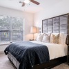 a bedroom with a window and lamps