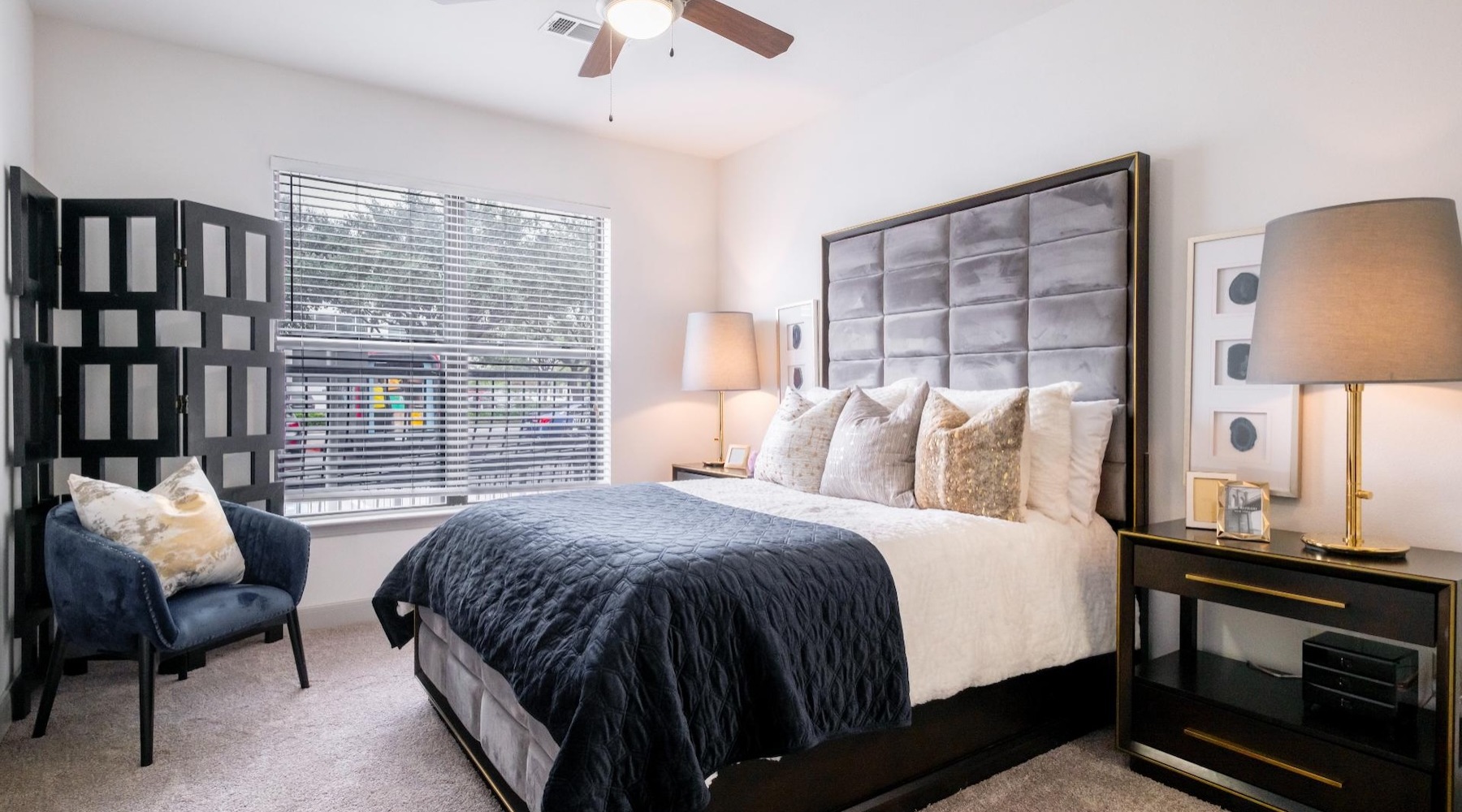 a bedroom with a window and lamps