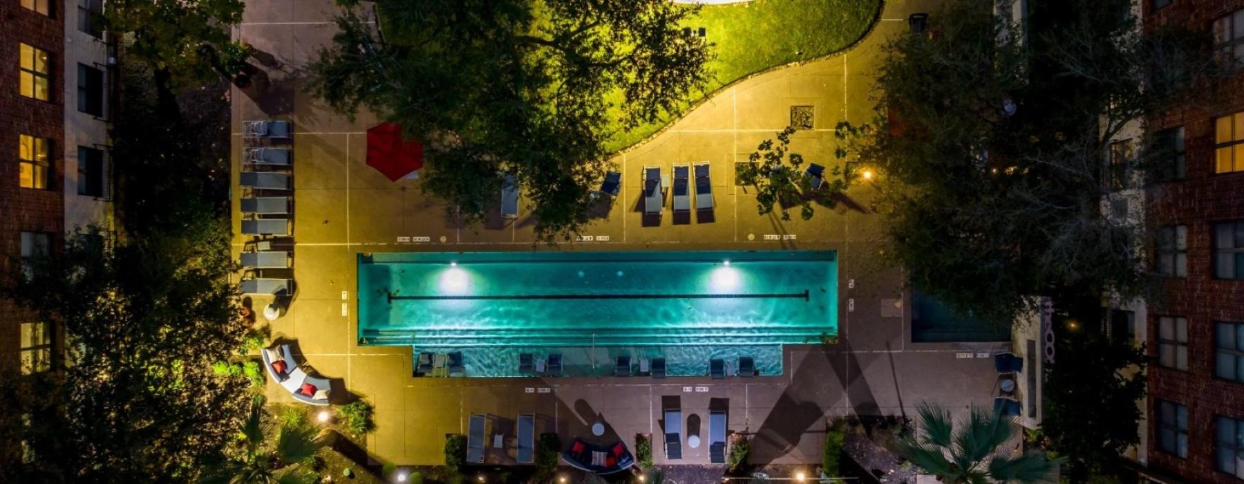 a building with a pool and trees