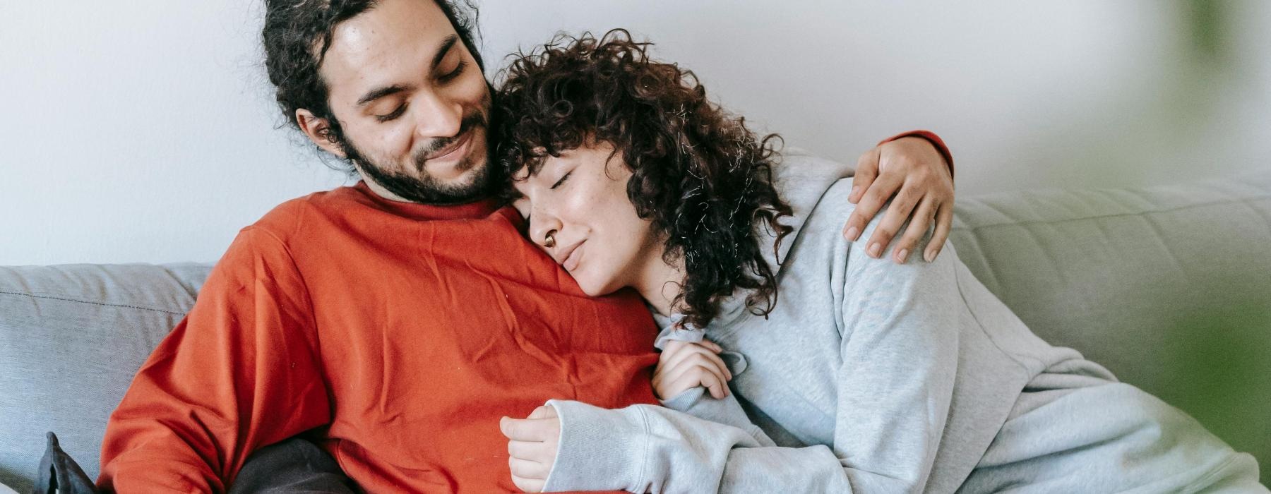 a man and woman sitting on a couch
