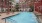 a pool in a courtyard between buildings